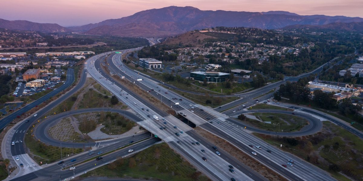 Twilight aerial view of the 91 Freeway through the community of Anaheim Hills in Anaheim, California, USA