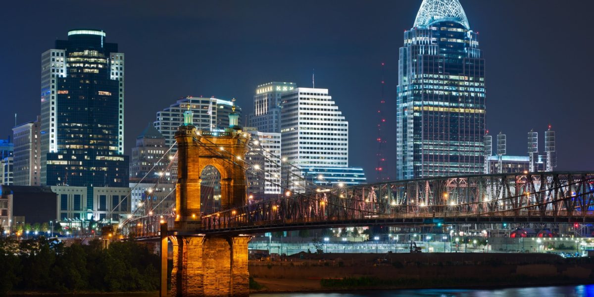 Cincinnati skyline. Image of Cincinnati and John A. Roebling suspension bridge at night.