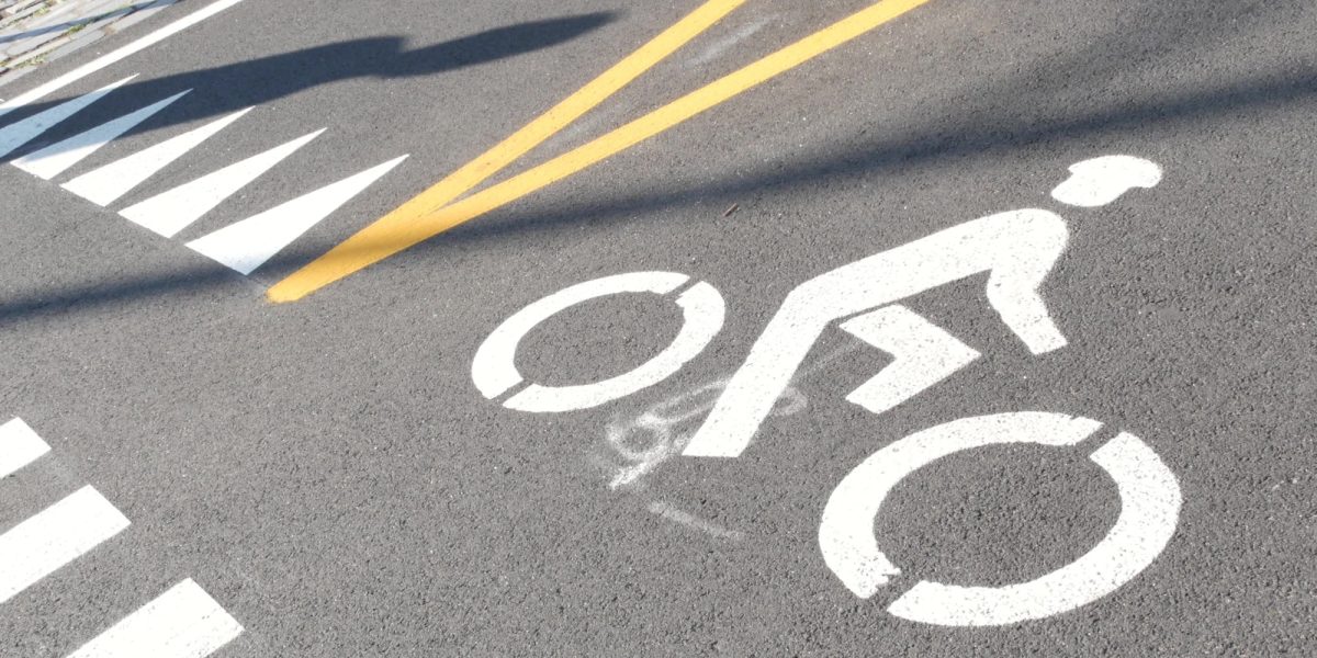 Bike lane asphalt sign, New York City. Bicycle path, cycle route for bicyclists, Manhattan. Way for roller skating and skates. Recreational sport activity infrastructure, biker cycling, United States.